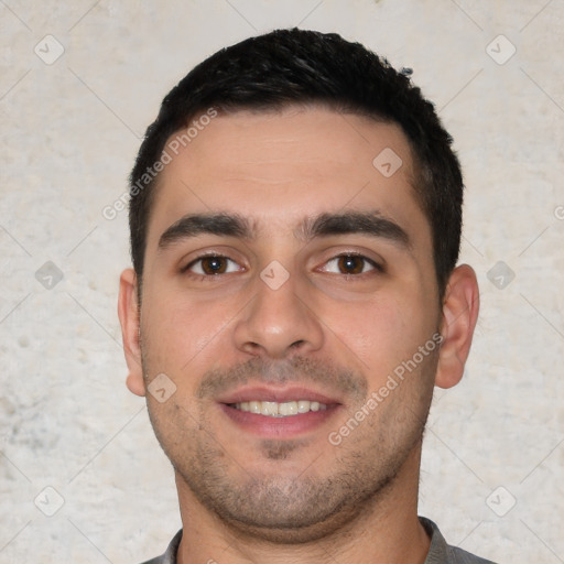 Joyful white young-adult male with short  black hair and brown eyes