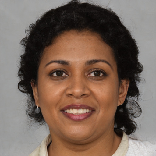 Joyful black young-adult female with medium  brown hair and brown eyes