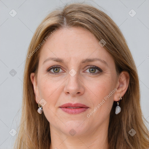 Joyful white adult female with long  brown hair and grey eyes