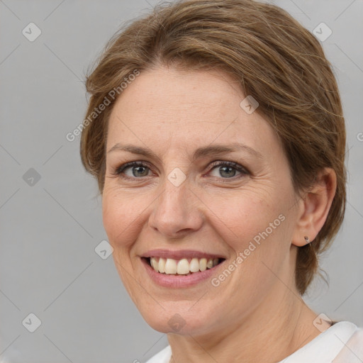 Joyful white adult female with medium  brown hair and grey eyes