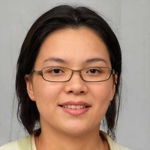 Joyful asian young-adult female with medium  brown hair and brown eyes