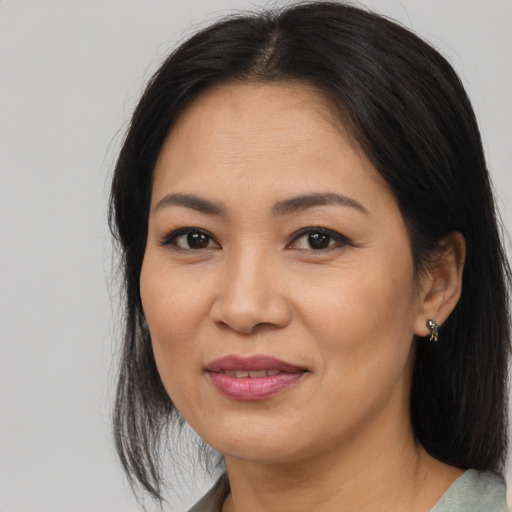 Joyful asian young-adult female with medium  brown hair and brown eyes
