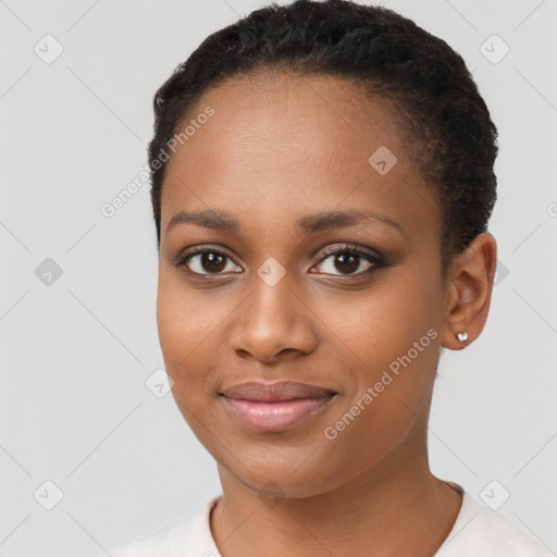 Joyful black young-adult female with short  black hair and brown eyes