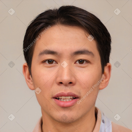 Joyful asian young-adult male with short  brown hair and brown eyes