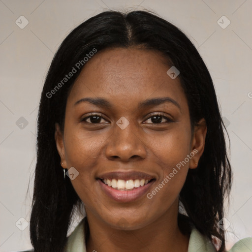 Joyful black young-adult female with long  brown hair and brown eyes