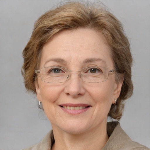 Joyful white middle-aged female with medium  brown hair and grey eyes