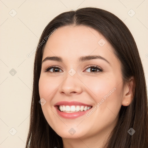 Joyful white young-adult female with long  brown hair and brown eyes