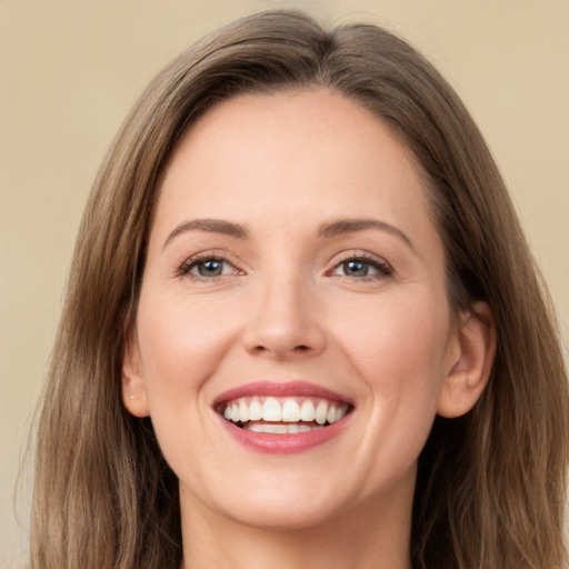 Joyful white young-adult female with long  brown hair and grey eyes