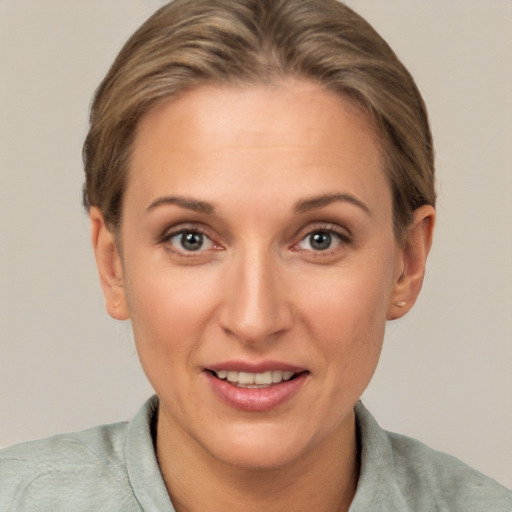 Joyful white adult female with short  brown hair and brown eyes