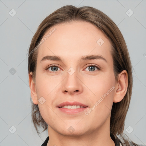 Joyful white young-adult female with medium  brown hair and grey eyes