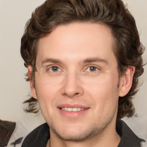 Joyful white adult male with medium  brown hair and grey eyes