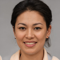 Joyful asian young-adult female with medium  brown hair and brown eyes