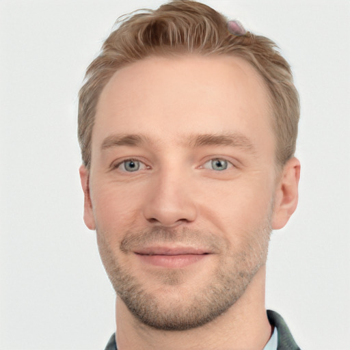 Joyful white young-adult male with short  brown hair and blue eyes