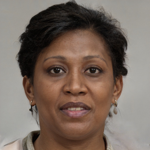 Joyful black adult female with medium  brown hair and brown eyes