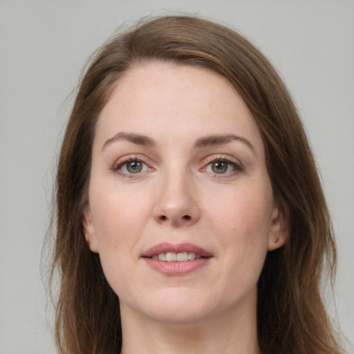 Joyful white young-adult female with long  brown hair and grey eyes