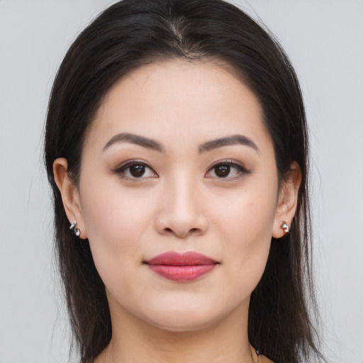 Joyful asian young-adult female with long  brown hair and brown eyes