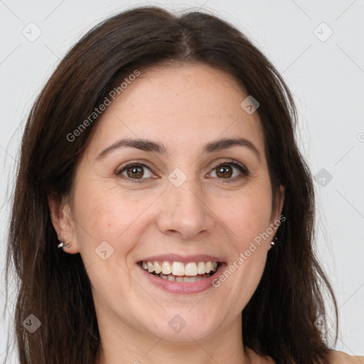 Joyful white adult female with long  brown hair and brown eyes