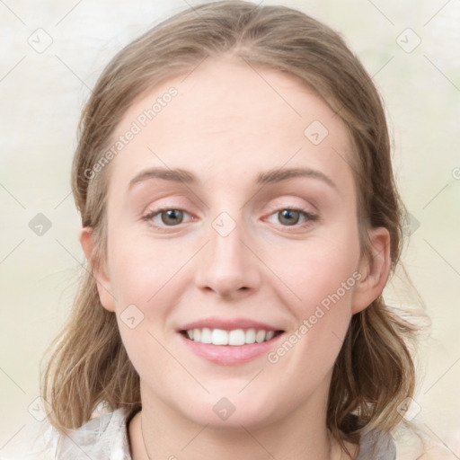 Joyful white young-adult female with medium  brown hair and blue eyes