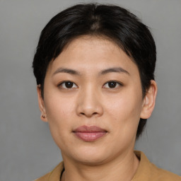 Joyful asian young-adult female with short  brown hair and brown eyes