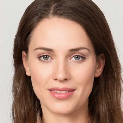 Joyful white young-adult female with long  brown hair and grey eyes