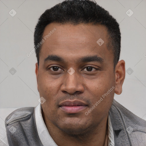 Joyful latino young-adult male with short  black hair and brown eyes
