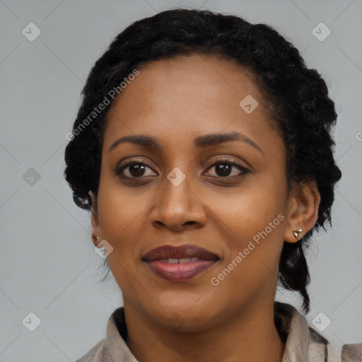 Joyful black young-adult female with long  brown hair and brown eyes