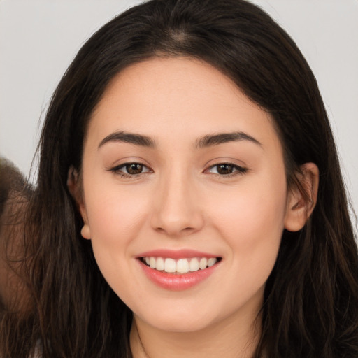 Joyful white young-adult female with long  brown hair and brown eyes