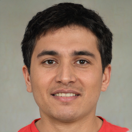 Joyful white young-adult male with short  brown hair and brown eyes