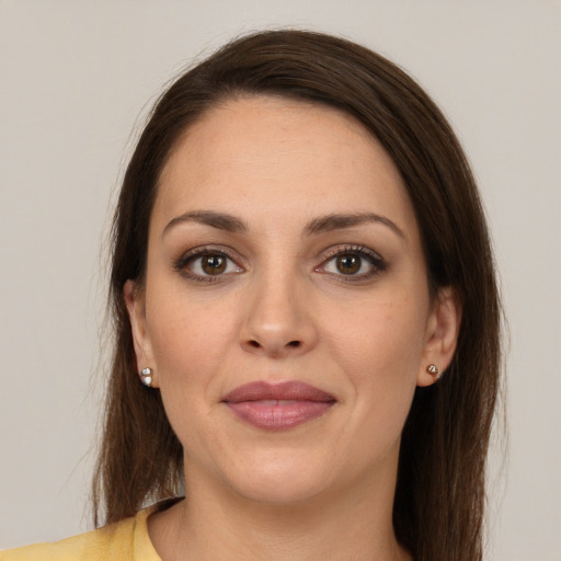 Joyful white young-adult female with long  brown hair and brown eyes