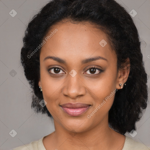 Joyful black young-adult female with long  black hair and brown eyes