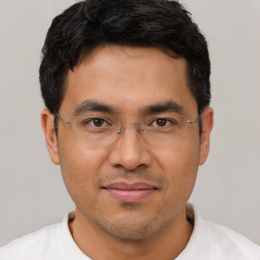 Joyful asian young-adult male with short  black hair and brown eyes