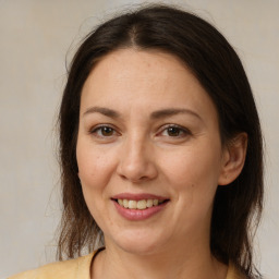 Joyful white adult female with medium  brown hair and brown eyes