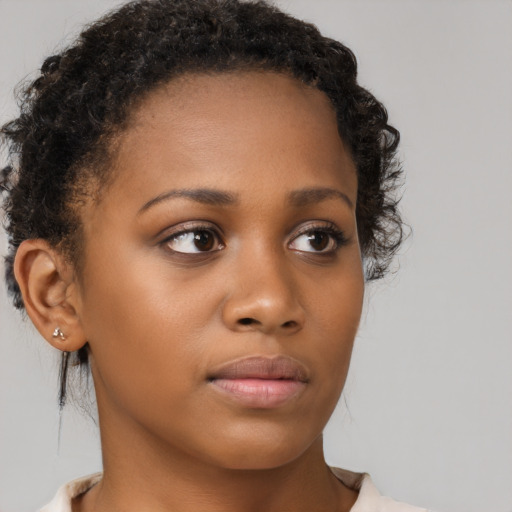 Neutral black young-adult female with medium  brown hair and brown eyes