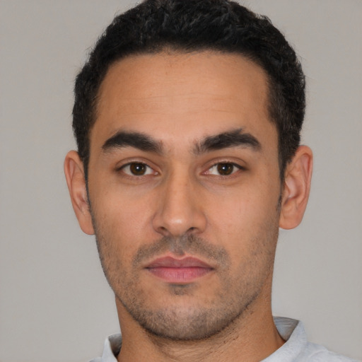Neutral white young-adult male with short  black hair and brown eyes