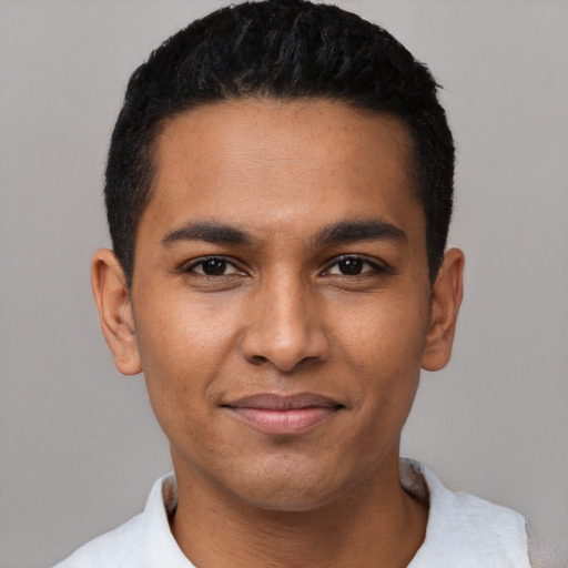 Joyful latino young-adult male with short  black hair and brown eyes