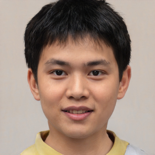 Joyful asian child male with short  brown hair and brown eyes