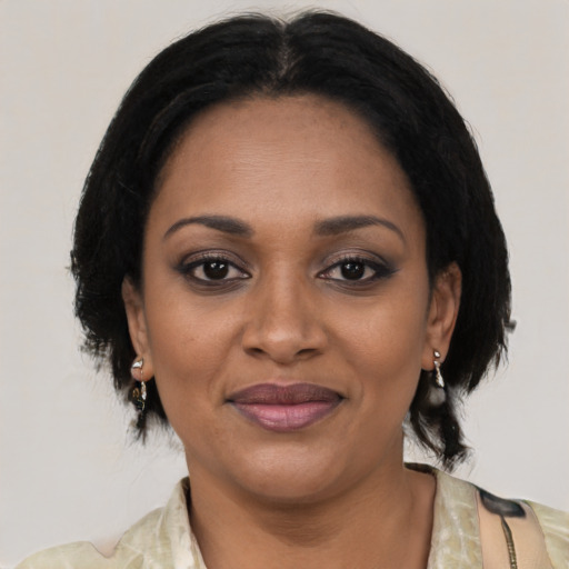 Joyful black adult female with medium  black hair and brown eyes