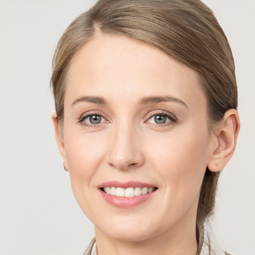 Joyful white young-adult female with long  brown hair and grey eyes