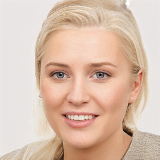 Joyful white young-adult female with medium  blond hair and blue eyes