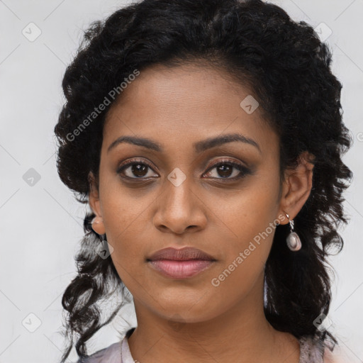 Joyful black young-adult female with long  black hair and brown eyes