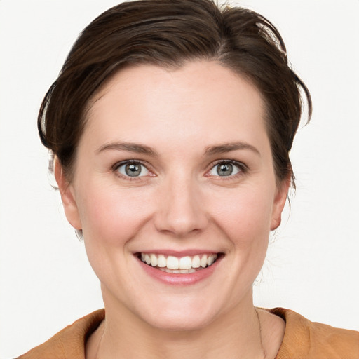 Joyful white young-adult female with short  brown hair and grey eyes