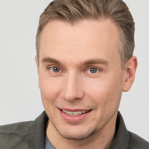 Joyful white adult male with short  brown hair and brown eyes