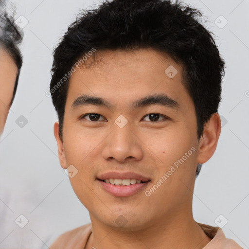 Joyful asian young-adult male with short  brown hair and brown eyes