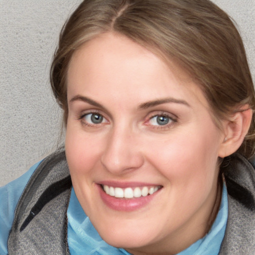 Joyful white young-adult female with medium  brown hair and blue eyes