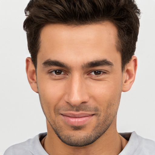 Joyful white young-adult male with short  brown hair and brown eyes