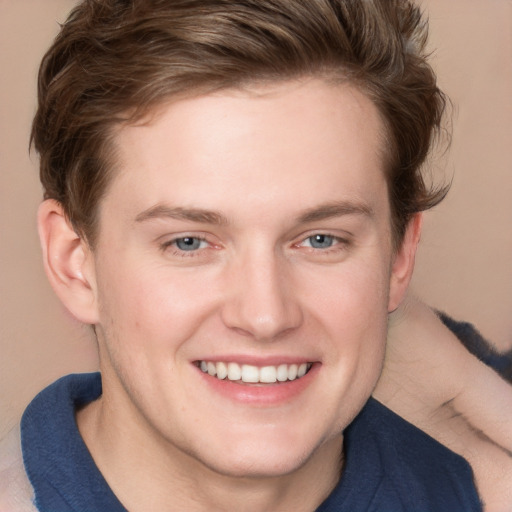 Joyful white young-adult male with short  brown hair and blue eyes