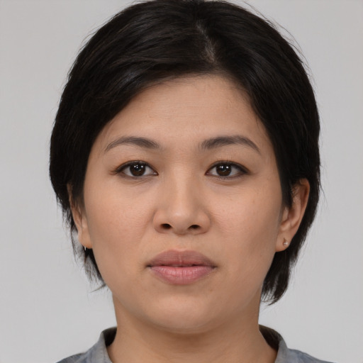 Joyful asian young-adult female with medium  black hair and brown eyes
