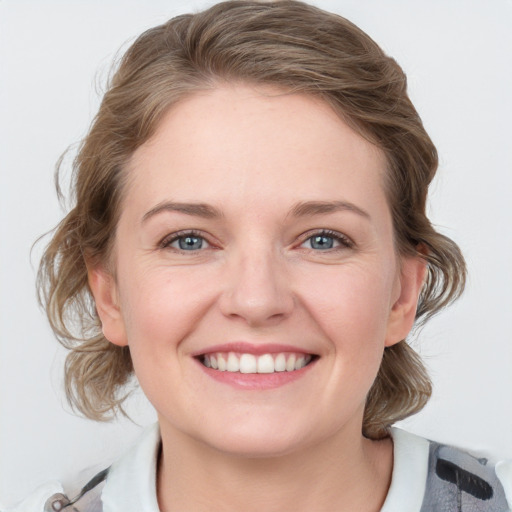 Joyful white young-adult female with medium  brown hair and grey eyes