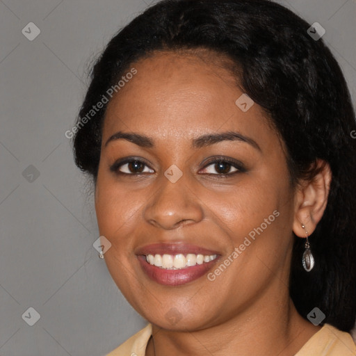 Joyful black young-adult female with long  brown hair and brown eyes