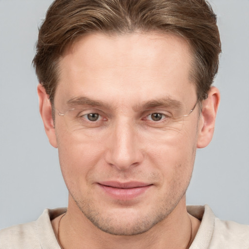 Joyful white adult male with short  brown hair and grey eyes